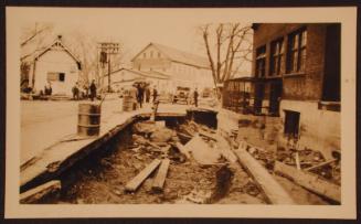 Men in Street Near Washed-Away Sidewalk