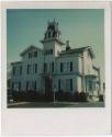 Three-story house with several peaked roofs and a mansard roof tower.  Gift of the Richard Well ...