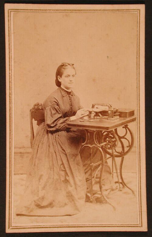 Woman in a Striped Dress at a Sewing Machine