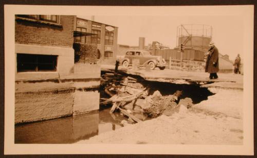 Man Looking at Part of the Street Washed Away