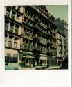 Tenement building with shops on street level, fire escapes visible, Gift of the Richard Welling…