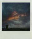 Pink and gray clouds (sunrise/sunset) over silhouette of roof, Gift of the Richard Welling Fami…