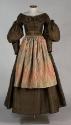 Gift of Annetta Eddy Brigham, 2001.49.9 (dress)  and Gift of Fred V. Dowding, 1912.13 (apron)  …