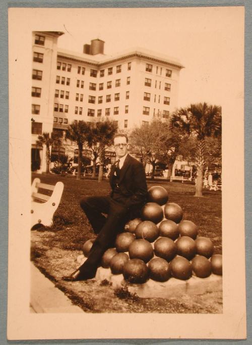 George Heck Seated on Cannonballs