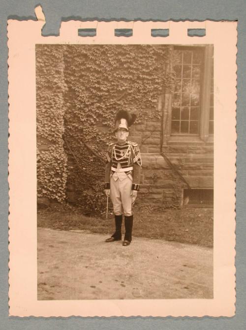 George Heck in Uniform in front of an ivy-covered wall