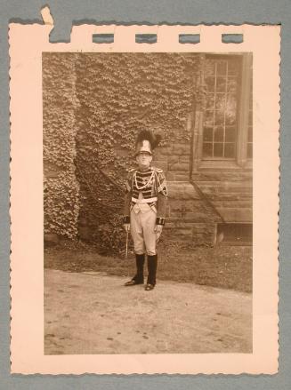George Heck in Uniform in front of an ivy-covered wall