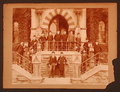 Men at an Entrace to a Ivy-covered Stone Building