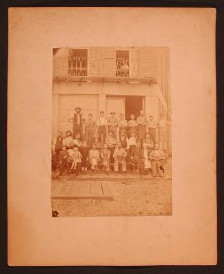 Group of Men in Front of Goodyear Shop