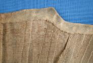 Top edge binding, proper right front, inside.