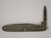 Maker's mark on blade and anniversary stamp.